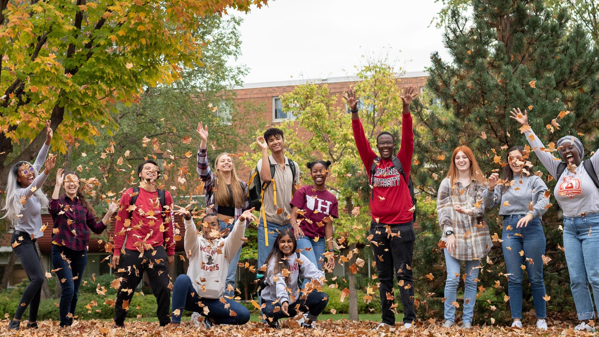  51 happy students at 51 during the fall blowing the leafs